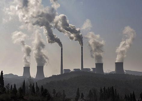 Smokestacks belch pollution at a huge power plant