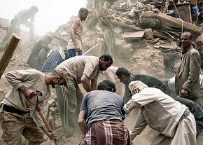 An emergency response team searches for victims in the rubble after a Saudi air strike in Sana'a